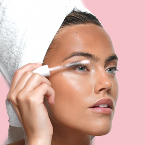 SWATI Cosmetics model brushing lashes with Tourmaline.