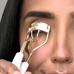 Swati Verma using eyelash curler.
